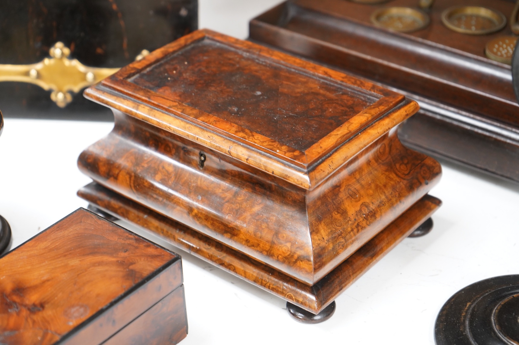 A collection of sundry items to include a Coromandel and brass mounted ink blotter pad, an early 19th century French yew veneered travelling writing box, an early 19th century mahogany desk stand and burr walnut bombé sh